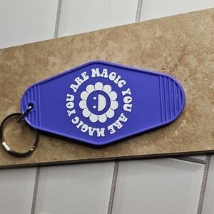 Motel Style Purple Keychain with Smiley Flower Design